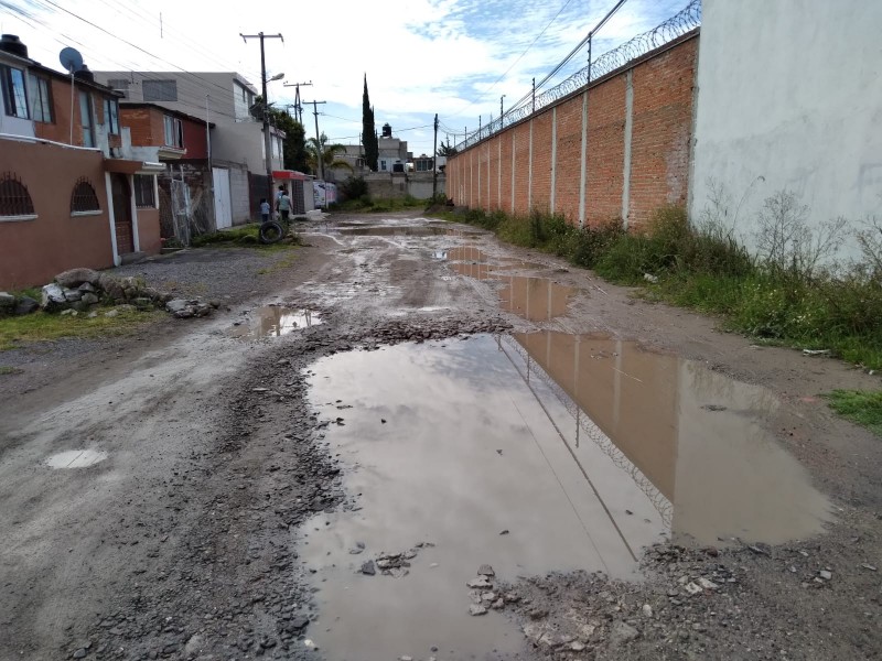 Baches afectan a calle de colonia San Isidro Castillotla