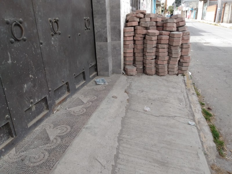 Invaden acera en Metepec