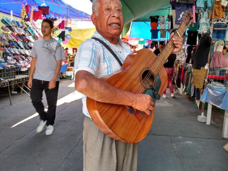 Músico busca obtener un ingreso en tianguis de la ciudad