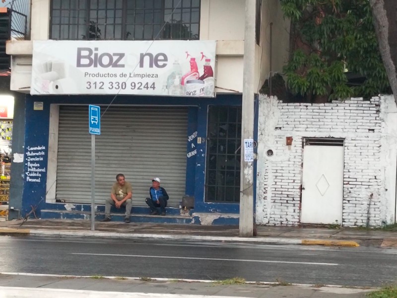 Sin paraderos, usuarios esperan el camión bajo la lluvia